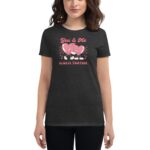 A woman is wearing a dark t-shirt featuring a playful graphic of two heart characters holding hands with the text You & Me ALWAYS TOGETHER above them on a checkered background.