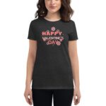 A woman is wearing a dark shirt featuring the text "HAPPY VALENTINE'S DAY" surrounded by floral designs depicting a festive theme for Valentine's Day.