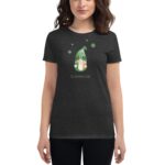 A person wears a black t-shirt displaying a gnome in a green hat surrounded by shamrocks with the text St. Patrick’s Day underneath designed for celebrating the holiday.