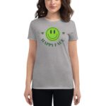 A woman wears a gray t-shirt featuring a large green smiley face graphic with the text HAPPY FACE above it in a casual setting