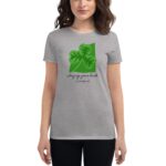 A woman wearing a light grey t-shirt displays green leaf graphics alongside text that reads Trying your luck It's Saint Patrick's Day against a plain backdrop.