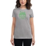 A woman wearing a grey t-shirt with green text and a rainbow graphic is smiling The shirt features the phrases All you need is luck and HAPPY ST PATRICK'S DAY