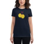 A woman is wearing a dark t-shirt featuring two smiling yellow olives with the text "OLIVE YOU" above them  set against a plain background.