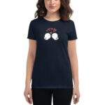 A woman wears a dark t-shirt featuring two cartoonish birds facing each other with closed eyes and hearts above them  suggesting affection in a casual setting.