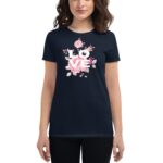 A woman is wearing a navy t-shirt featuring the word LOVE in bold white letters  surrounded by colorful flowers and leaves  against a simple light background.