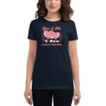 A woman wears a dark t-shirt featuring cartoon hearts holding hands. The text reads "You & Me ALWAYS TOGETHER" with a playful design set against a checkered background.