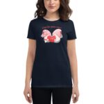 A navy t-shirt featuring two cartoon gnomes holding a red heart with the text A love like gnome other above them the person wearing it stands in a neutral pose.