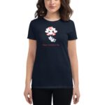 A woman wears a navy t-shirt featuring a playful cat among floating red and white hearts with the text Happy Valentine's Day below the design in a festive context.