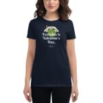 A woman is wearing a navy blue t-shirt featuring the text Everyday is Valentine’s Day decorated with daisies and a butterfly in a neutral background.
