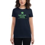 A woman wears a black T-shirt displaying green text that reads Let's Get Lucky and Happy St. Patrick's Day with a green clover above the text.