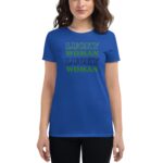 A blue t-shirt features the words "LUCKY WOMAN" displayed in alternating colors of green and black  worn by a woman with wavy hair standing against a plain background.