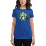 A blue t-shirt features the word "EXPECTATION" in bold black letters  surrounded by a green leafy wreath. A person stands  holding the shirt against a neutral background.