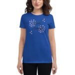 A person wears a vibrant blue t-shirt featuring the text Love Always surrounded by decorative elements including circular and diamond shapes standing against a plain background.