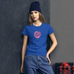 A young woman leans against a dark wall wearing a blue t-shirt featuring a rose design and the word love casual denim jeans and a navy beanie complete her look