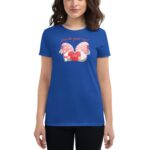 A blue t-shirt features a whimsical graphic of two cartoon gnomes holding a red heart with the word LOVE surrounded by playful elements and the text A love like gnome other above them.