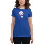 A blue t-shirt features a playful cat surrounded by red and white hearts above it with the text Happy Valentine's Day below the design worn by a woman.
