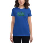 A blue t-shirt features green text that reads St Patrick's Day with decorative elements like shamrocks and festive accents worn by a woman in a casual setting.