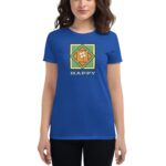 A woman wears a blue t-shirt featuring a graphic design of a green and orange pattern with the word HAPPY and the phrase ST PATRICK'S DAY beneath it in white text.
