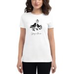 A woman wearing a white t-shirt with a black graphic of two birds on a branch surrounded by hearts and the text Spring in the air below the graphic.