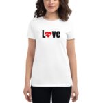 A woman stands wearing a white t-shirt with the word Love in black text featuring a red heart symbol intertwined with hands  creating a warm and affectionate vibe.