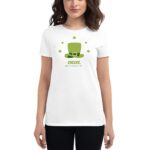 A woman wears a white t-shirt featuring a green leprechaun hat design with clovers and text that reads CHEERS HAPPY ST PATRICKS DAY in a festive context.
