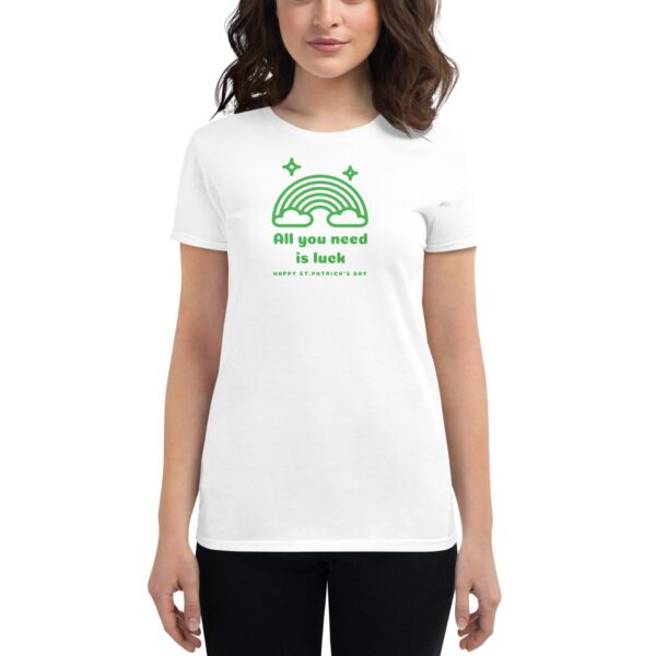 A woman is wearing a white t-shirt displaying a green graphic of a rainbow with the text All you need is luck Happy St Patrick's Day against a plain background.