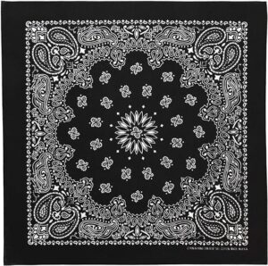 A black bandana features intricate white paisley and floral patterns at the center radiating outwards  creating a symmetrical design that fills the fabric with decorative elements.