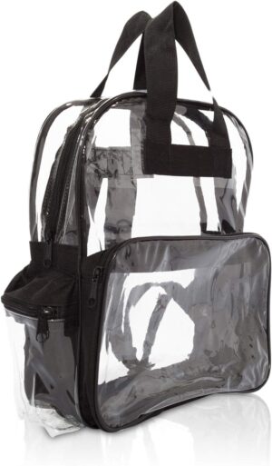 A clear backpack made of transparent plastic with black fabric accents is displayed upright with zippers and handles visible showcasing its compartments in a simple clean setting.