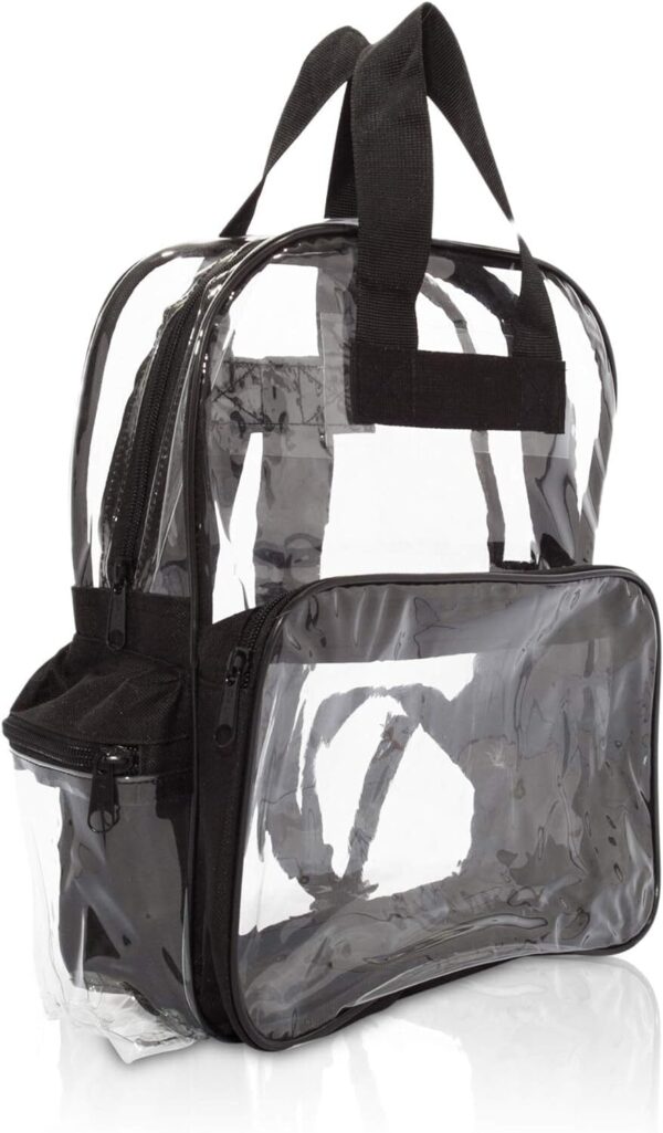A clear backpack made of transparent plastic with black fabric accents is displayed upright with zippers and handles visible showcasing its compartments in a simple clean setting.