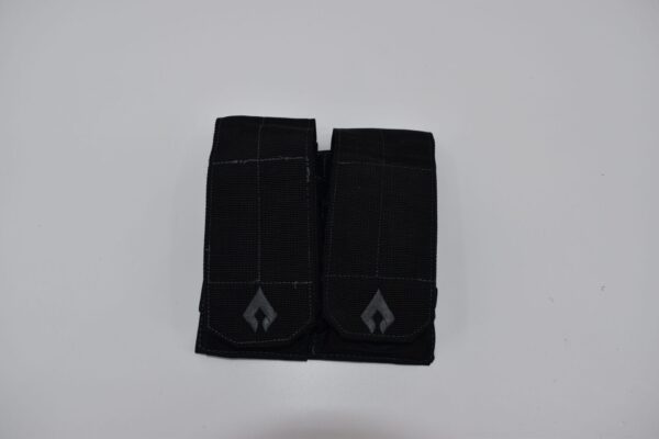 A dual pocket pouch made of black fabric features two secured compartments with flap closures placed on a plain white background  designed for carrying small items or tools.