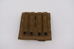 A tactical pouch is positioned flat with multiple straps and button closures on the front indicating its use for carrying gear in outdoor or military settings against a plain white background.