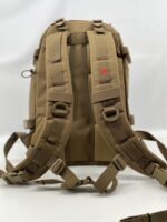 A tan backpack with multiple straps and clips is positioned upright against a neutral background showcasing its padded back and ergonomic design for comfort and utility.