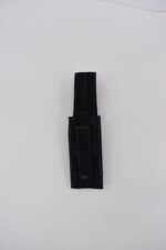 A black nylon holster stands upright on a white background showcasing multiple straps and a button closure designed for securing a tool or knife in a practical context.