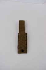 A brown tactical pouch is positioned upright on a white background with a strap extending from the top and a snap button at the bottom for securing contents.