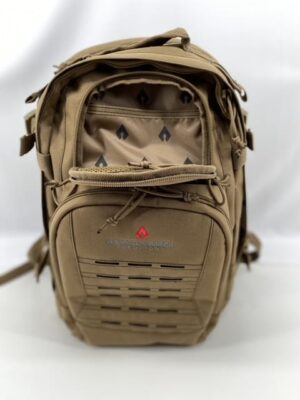 A tan tactical backpack stands upright showcasing multiple compartments and straps it features a logo on the front and has a geometric pattern inside the main compartment