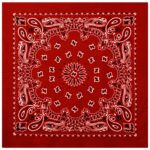 A red bandana features intricate white and black paisley patterns with a central floral design surrounded by smaller motifs creating a detailed symmetrical layout against a solid background.