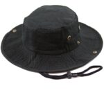 A black bucket hat sits upright showcasing its wide brim and textured fabric with metal eyelets and a drawstring for securing it under the chin in outdoor settings.