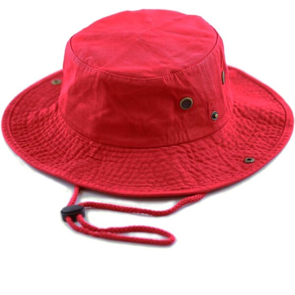 A red bucket hat rests flat with a wide brim and textured surface featuring two metal eyelets on the side and an adjustable chin strap below.
