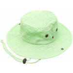 A green bucket hat rests flat with a wide brim and an adjustable chin strap showing metal eyelets for ventilation designed for outdoor wear to provide sun protection.