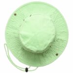 A wide-brimmed light green hat rests flat with a rounded top and a chin strap featuring a toggle. The background is plain and undistracting.
