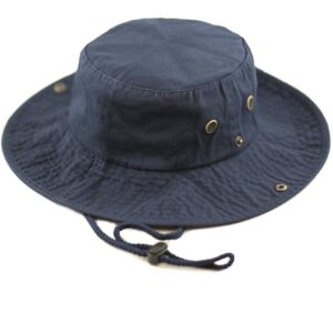 A navy blue bucket hat rests on a white surface featuring a round crown and a wide brim with ventilation holes and an adjustable chin strap for secure wear.