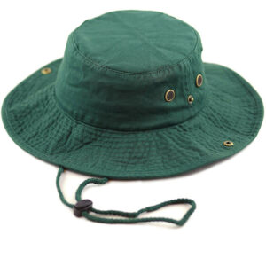A green bucket hat sits on a flat surface with a wide brim and a drawstring for adjustment featuring small ventilation grommets on the sides showcasing a casual outdoor accessory.
