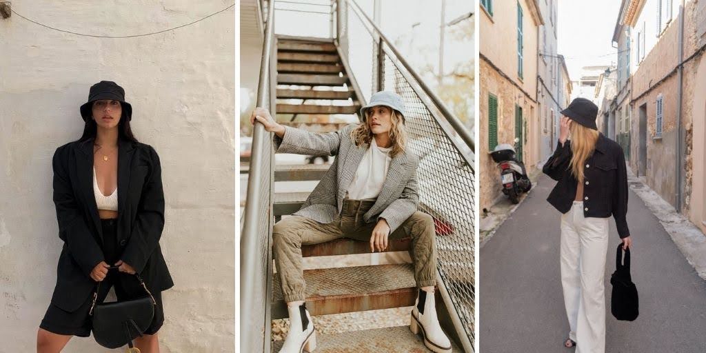 Fashionable women confidently model various outfits paired with stylish bucket hats. One wears a black blazer with a matching black bucket hat, another pairs a gray blazer with a bold blue bucket hat, and the third showcases a black jacket with wide-leg pants and a neutral-toned bucket hat. Each look highlights the versatility and trendiness of bucket hats in modern fashion.