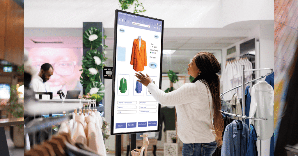 Woman interacting with a digital touchscreen in a clothing store, browsing a vibrant orange jacket. The scene conveys a modern, tech-savvy shopping experience.