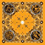A vibrant orange bandana features four circular images surrounded by intricate black and white patterns. Each circle contains illustrations labeled with the words Faith  Hope  Love  and Strength  emphasizing positivity.