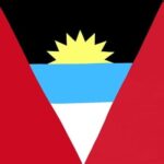 A triangular flag features red sides with a central blue band containing a yellow sun with black rays above it and a white section below  representing its national identity.