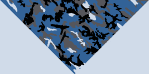 A patterned surface features a blue camouflage design with various black gray and white shapes intermingled creating an abstract appearance in a triangular layout against a solid light background.