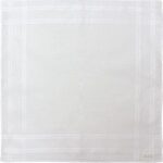A plain white cloth is laid flat displaying a subtle grid pattern. It serves as a background for dining or decorative purposes in a simple and elegant setting.