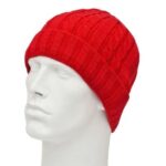 A red knitted beanie rests on a white mannequin head showcasing its textured pattern and snug fit in a neutral setting with no distinct background elements.