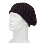A black knitted beanie is resting atop a white mannequin head showcasing its loose fit and textured pattern against a plain background emphasizing the beanie's design and style.